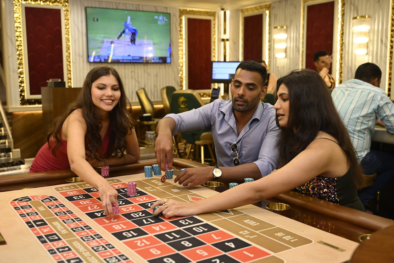 Group of adults enjoying a night of gambling at a casino in Candolim, Goa.